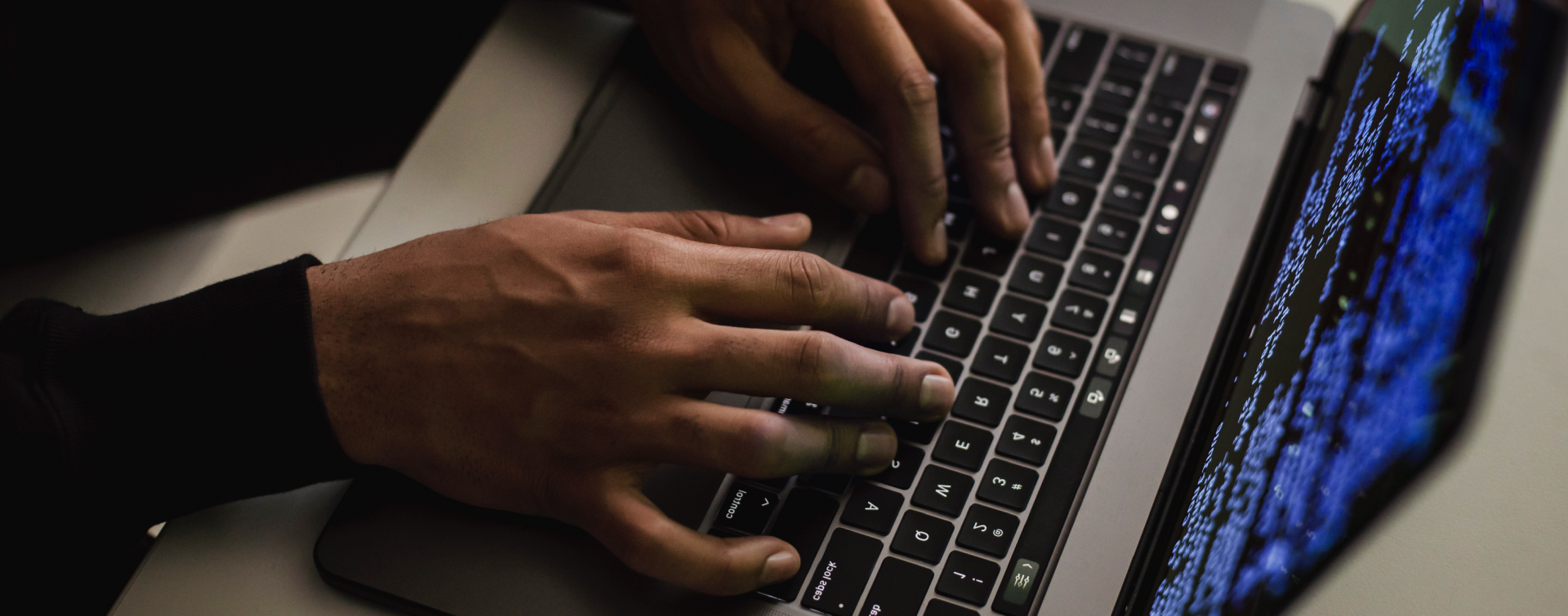Hands typing on a keyboard, emphasizing cybersecurity, security audits, and bug bounty programs.